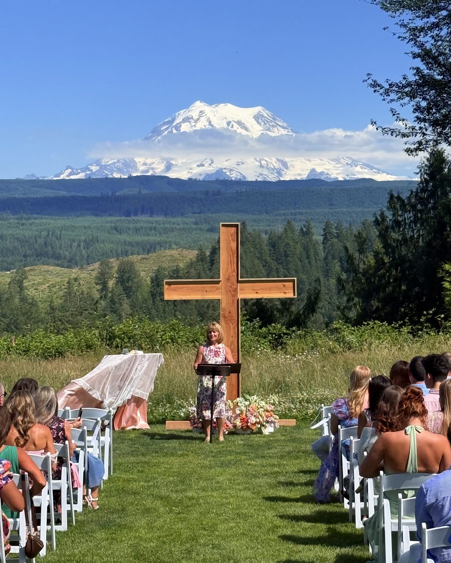 Rhonda leading a ceremony on a lawn with Mount Rainier in the distance